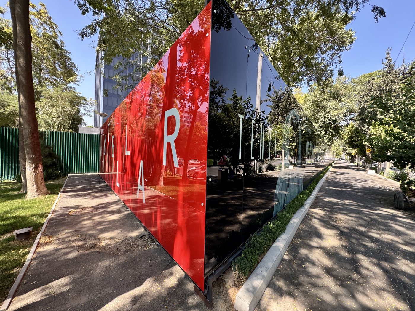 Colour and mirror glass hoarding panels on the same perimeter