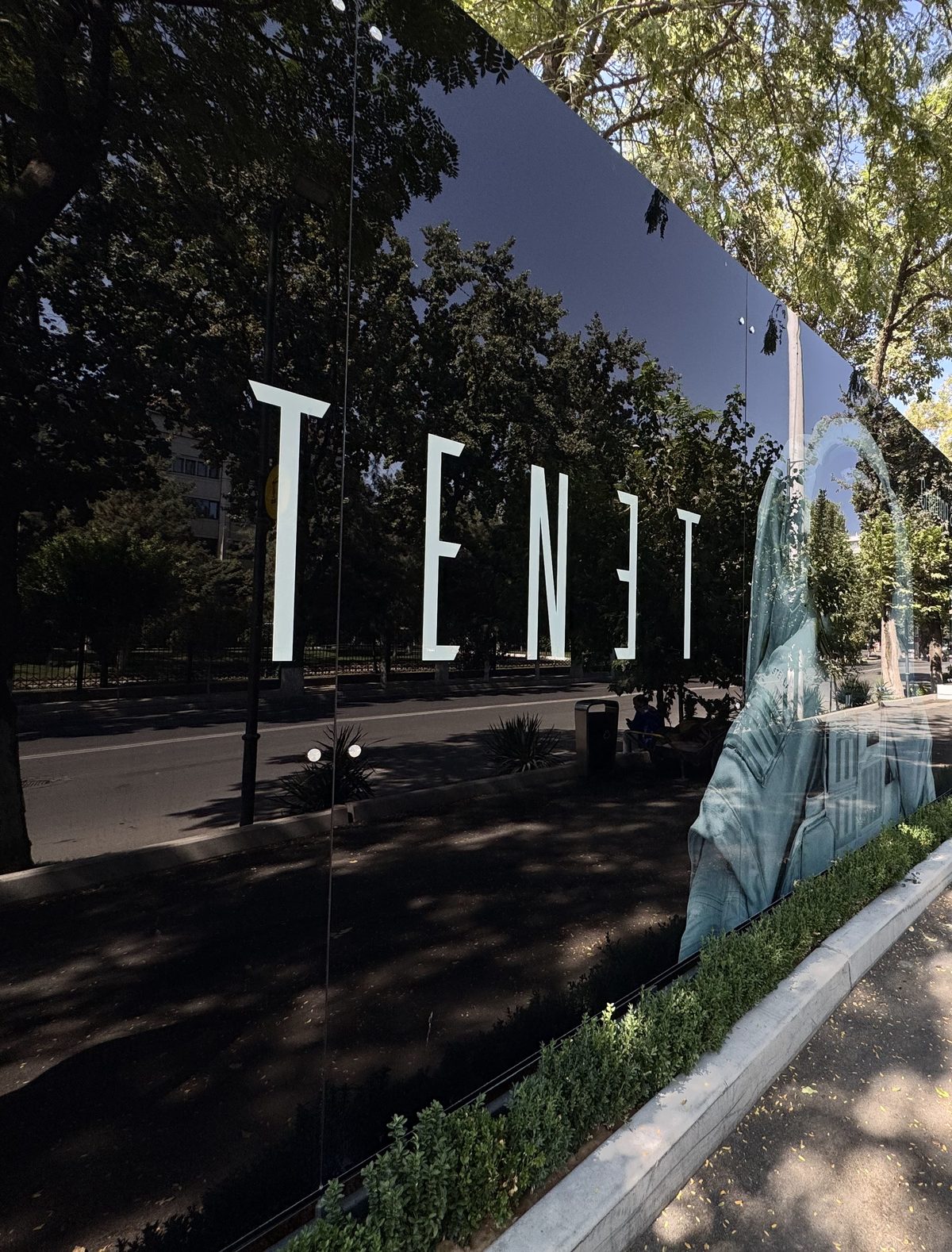 Mirror glass hoarding panels with large lettering on a construction site in Tashkent